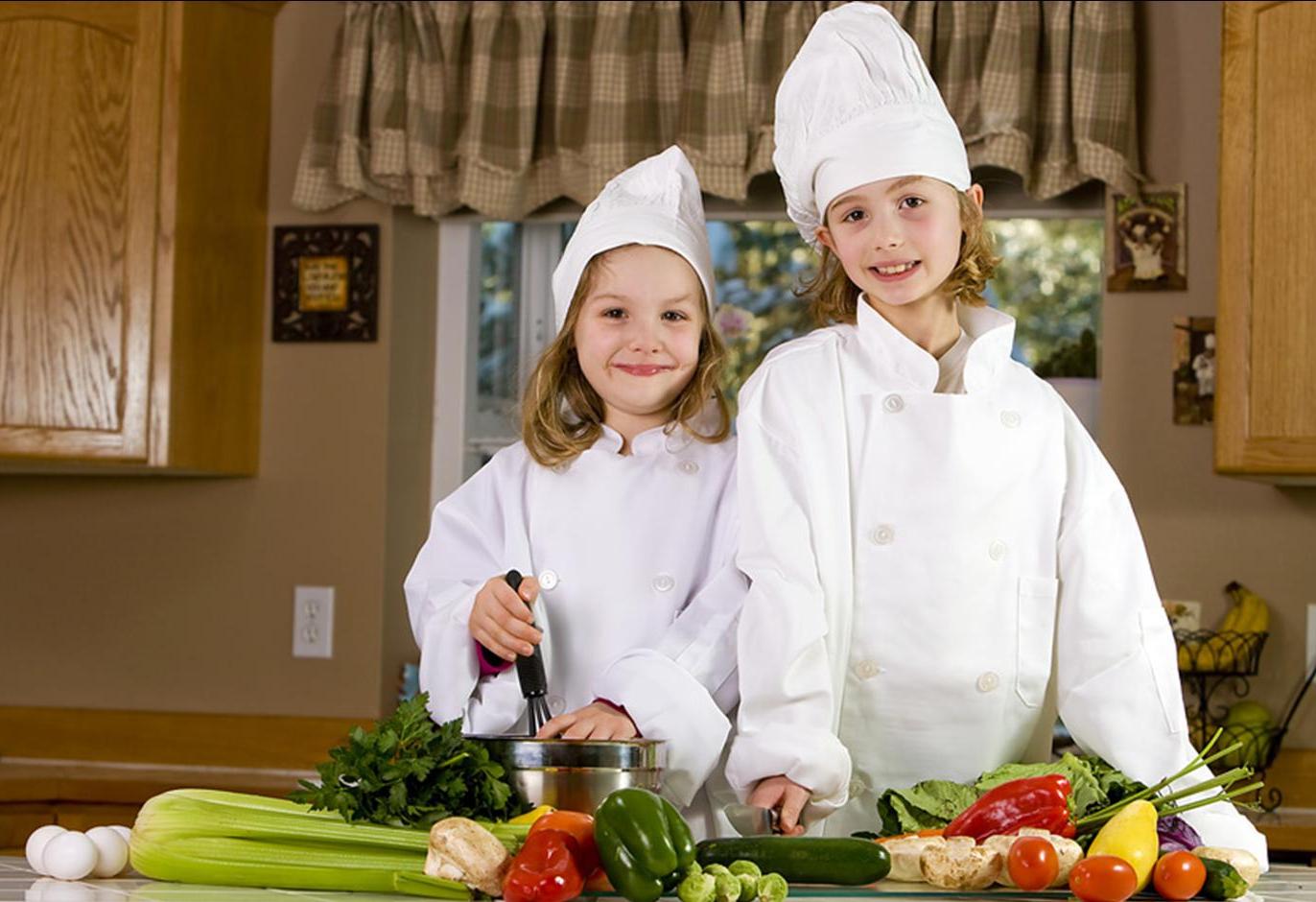 cute kids in chef hats prepare meal